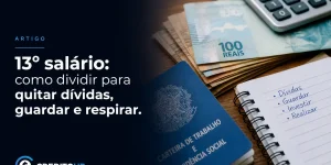 Notas de 100 reais, moedas e Carteira de Trabalho com 13º salário